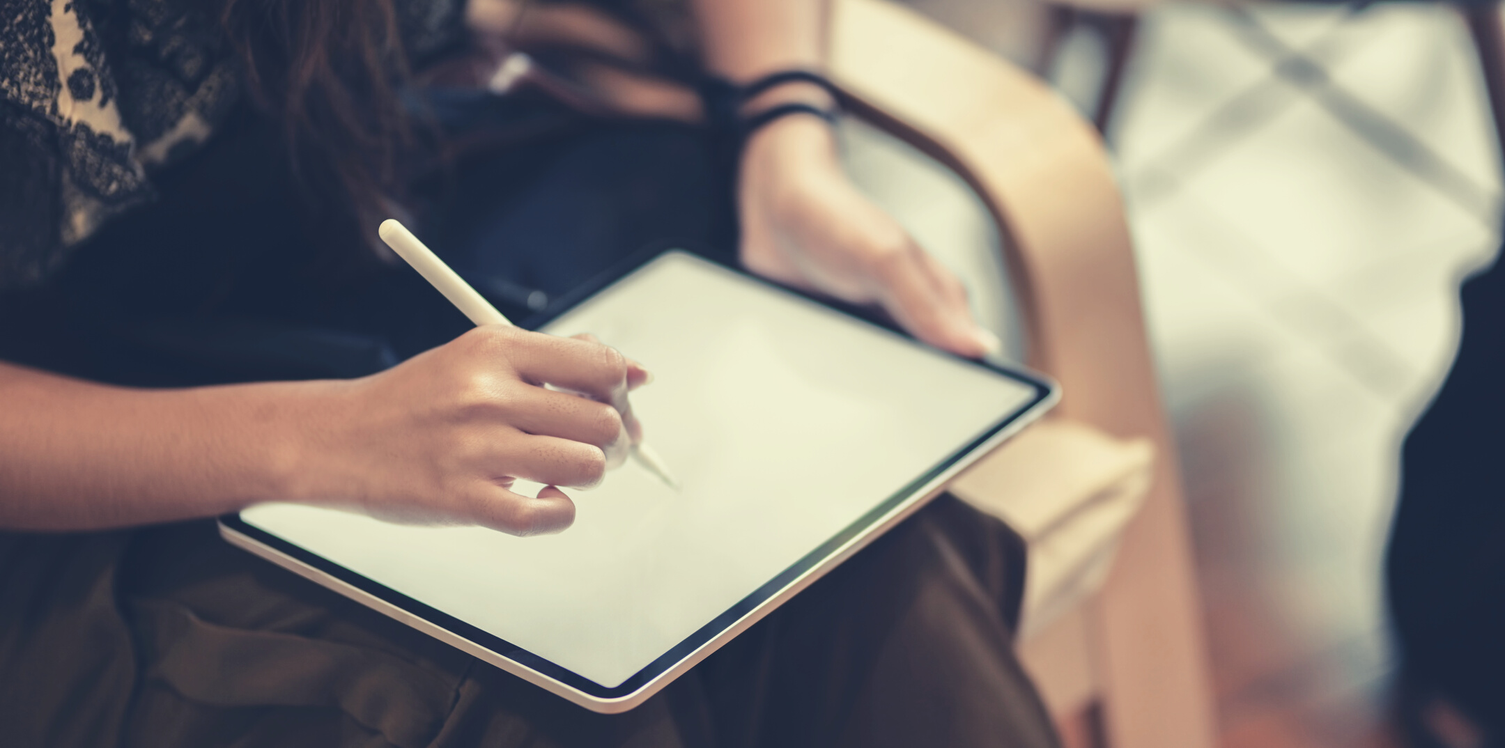 Crop unrecognizable graphic designer drawing on tablet with stylus